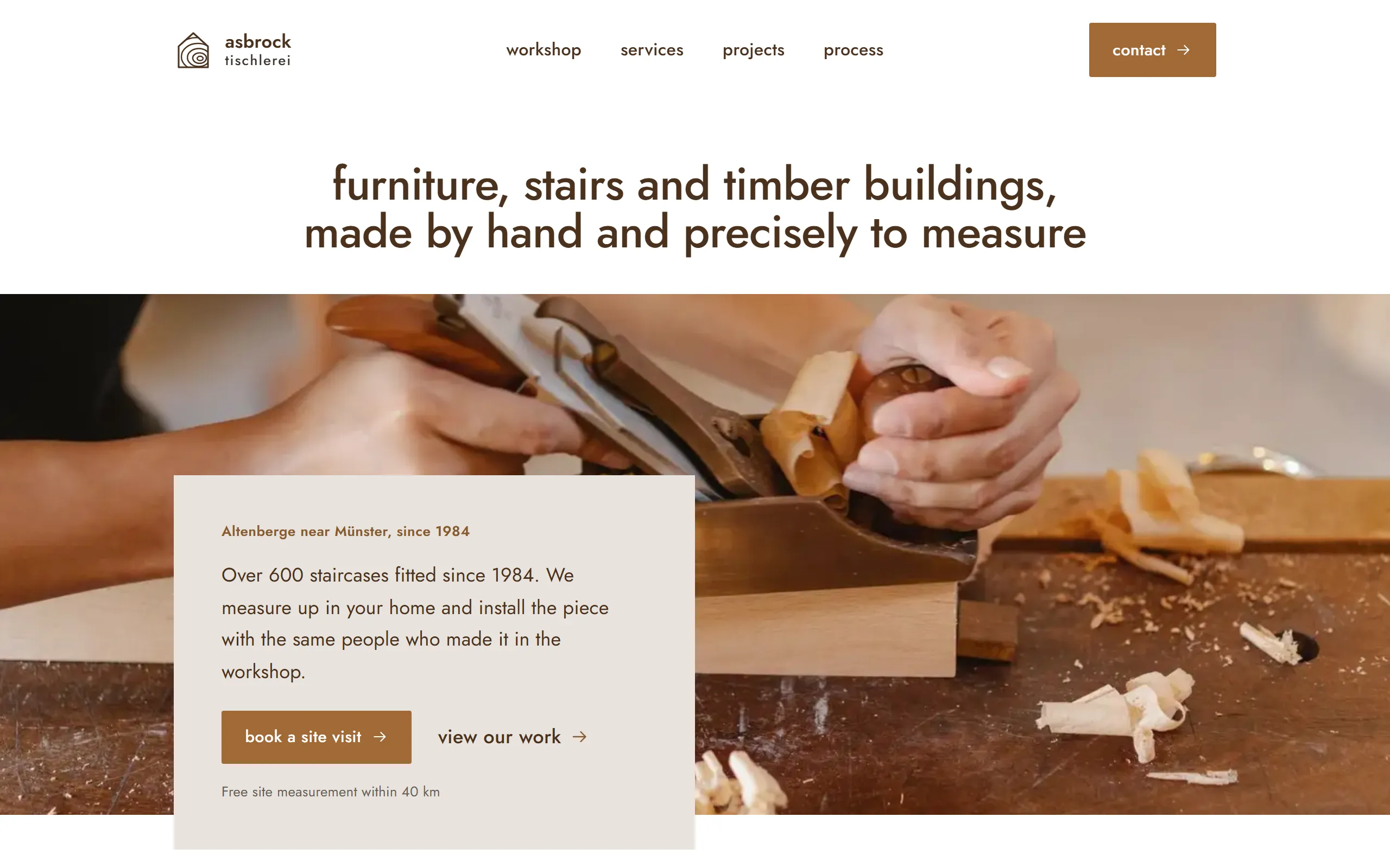 Home page of the Asbrock template with hands guiding a hand plane over a board and a beige panel with the heading